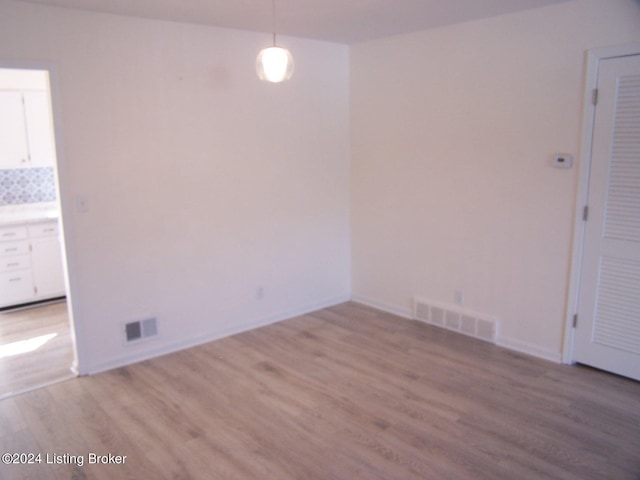 spare room with hardwood / wood-style floors