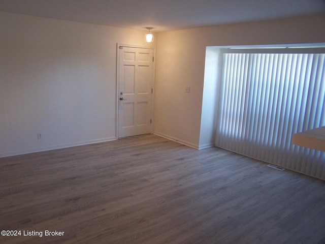 unfurnished room featuring wood-type flooring