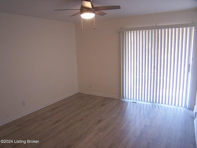 unfurnished room with ceiling fan, hardwood / wood-style flooring, and a wealth of natural light