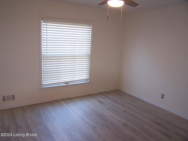 empty room with ceiling fan and hardwood / wood-style flooring