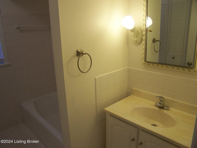 bathroom featuring tile patterned floors, vanity, tile walls, and decorative backsplash