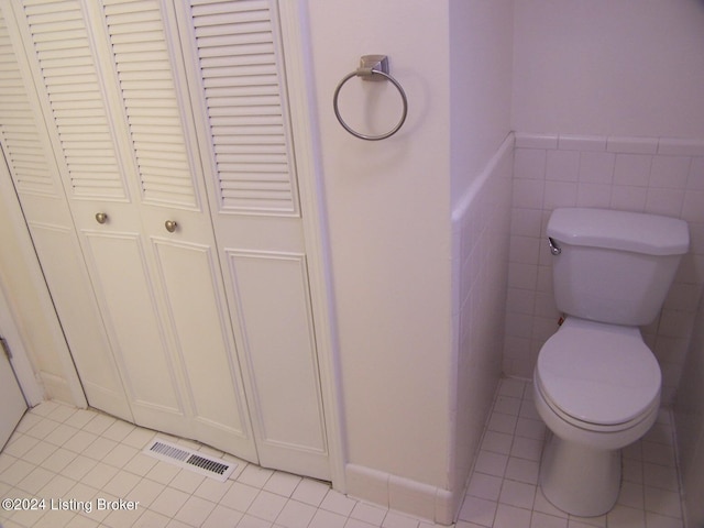 bathroom featuring tile walls, toilet, and tile patterned floors