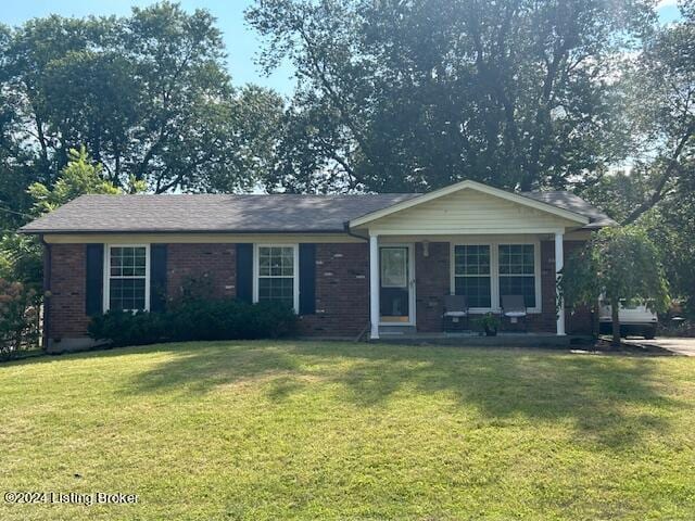 single story home with a front yard and covered porch