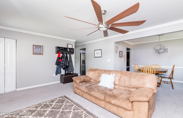 living room with ceiling fan, ornamental molding, and light carpet