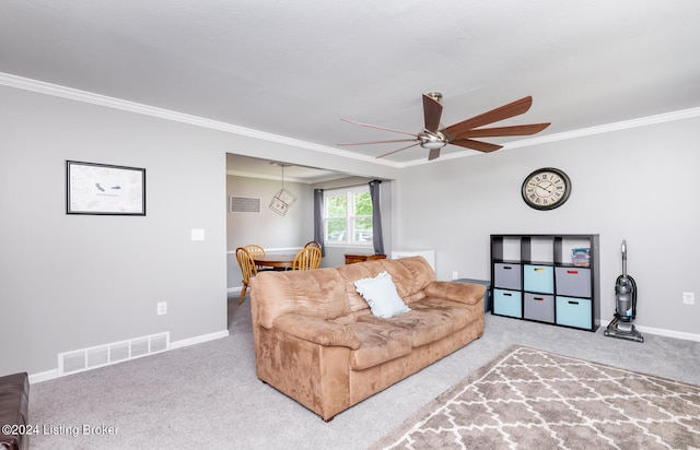 living room featuring ceiling fan, carpet flooring, and ornamental molding