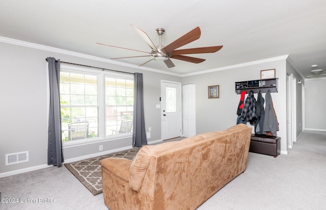 carpeted living room with ceiling fan and ornamental molding