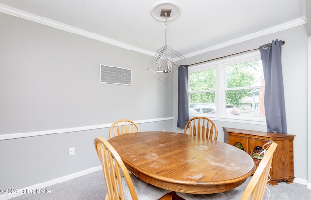 dining area featuring crown molding and carpet floors