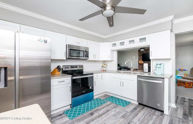 kitchen featuring stainless steel appliances, light hardwood / wood-style floors, white cabinetry, ceiling fan, and sink