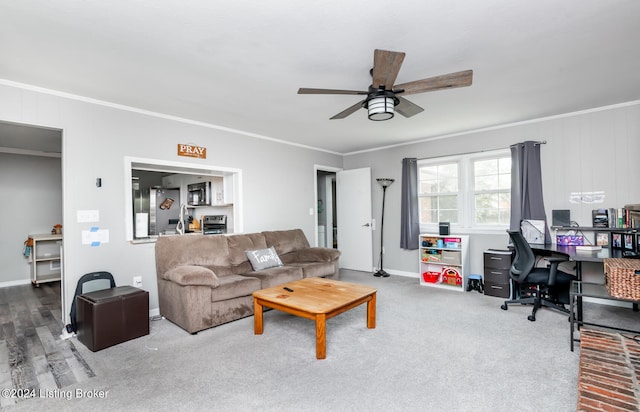 carpeted living room with ceiling fan and ornamental molding