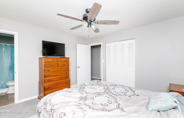 bedroom featuring ceiling fan, ensuite bathroom, carpet floors, and a closet