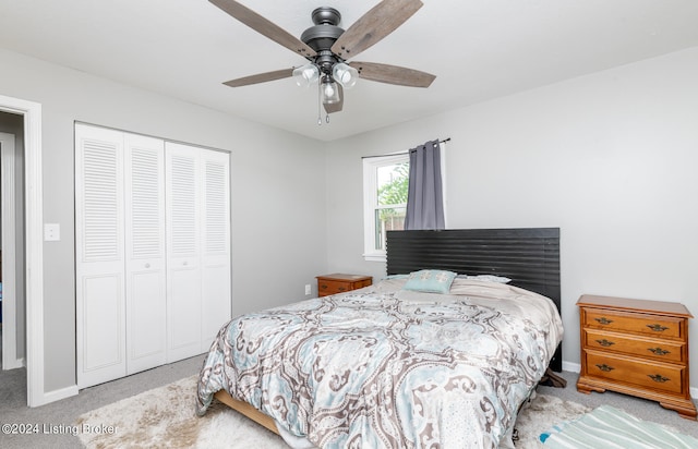 bedroom with ceiling fan, a closet, and light colored carpet