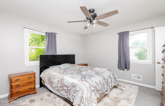 bedroom with ceiling fan and light colored carpet