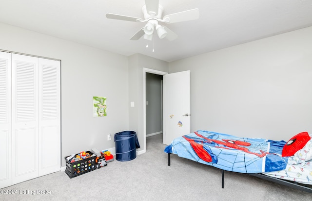 carpeted bedroom featuring a closet and ceiling fan