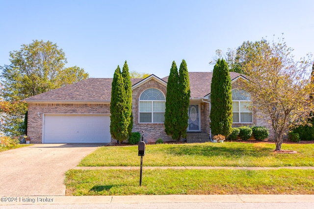 view of front of home featuring a front yard and a garage