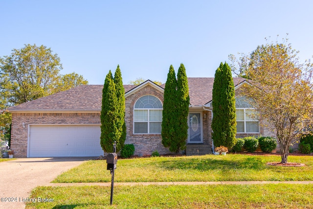 view of front of home featuring a front yard and a garage