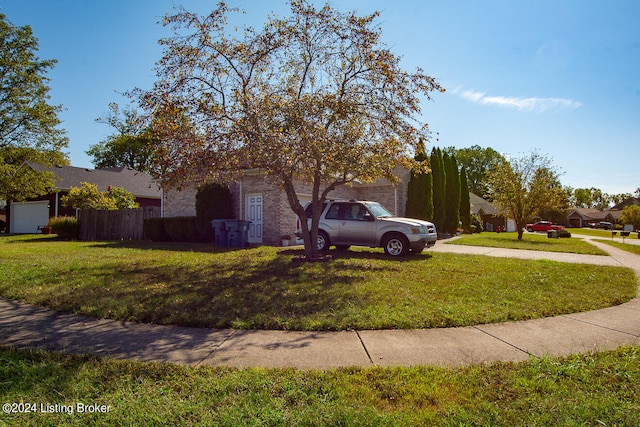 obstructed view of property with a front yard