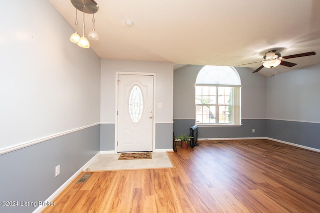 entrance foyer featuring light hardwood / wood-style flooring, vaulted ceiling, and ceiling fan