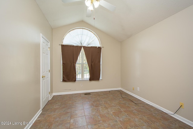 spare room featuring vaulted ceiling and ceiling fan