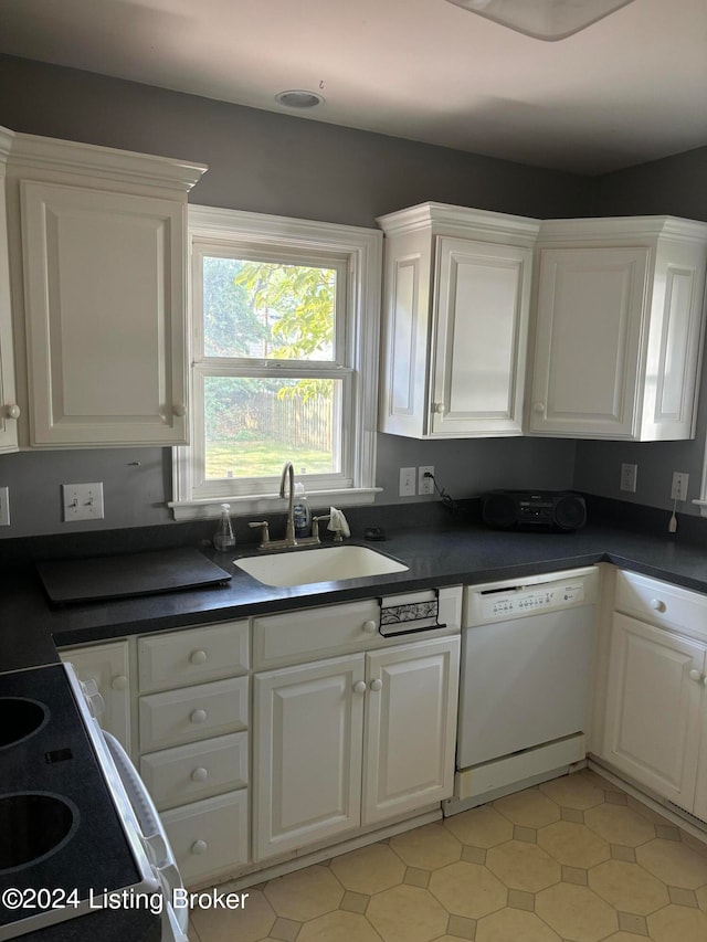 kitchen featuring sink, light tile patterned flooring, white cabinetry, and white dishwasher