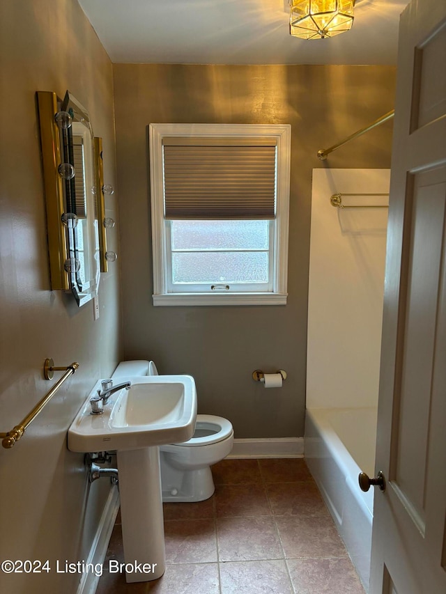 bathroom featuring tub / shower combination, toilet, and tile patterned floors