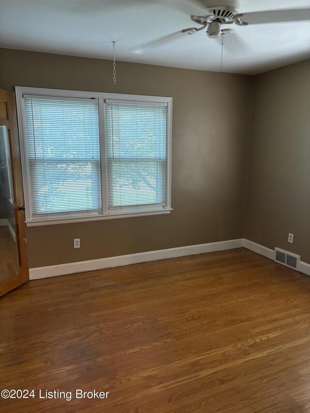 unfurnished room with hardwood / wood-style flooring and ceiling fan