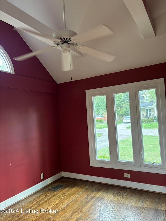 empty room with ceiling fan, a healthy amount of sunlight, and wood-type flooring