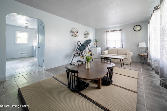 dining area featuring a textured ceiling and tile patterned floors