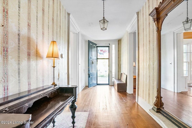 interior space featuring hardwood / wood-style floors, crown molding, and plenty of natural light