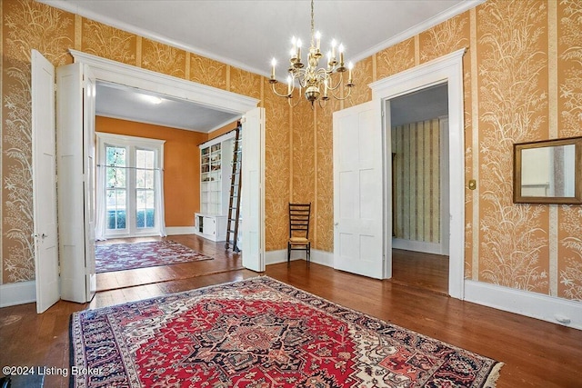 interior space featuring crown molding, dark hardwood / wood-style floors, and an inviting chandelier