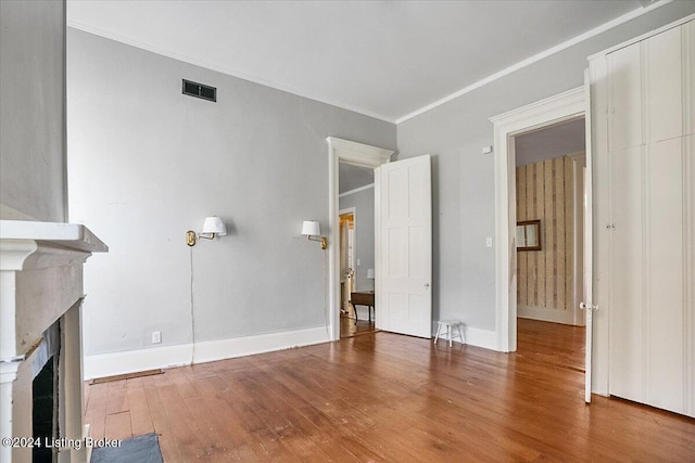 interior space featuring ornamental molding and hardwood / wood-style floors