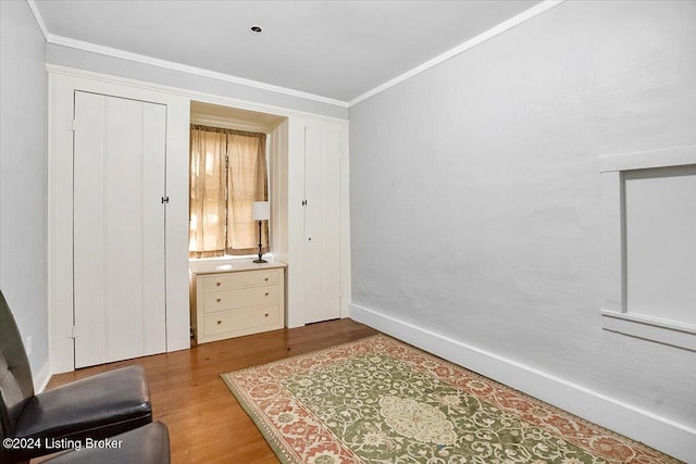 interior space with crown molding and hardwood / wood-style flooring