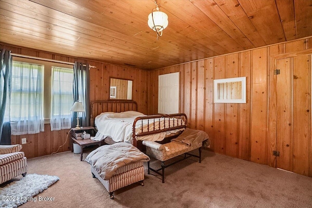 bedroom with carpet, wood ceiling, and wooden walls