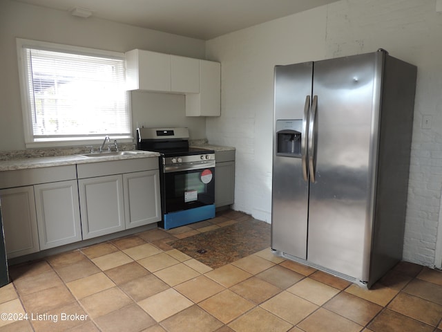 kitchen featuring light tile patterned floors, sink, and stainless steel appliances