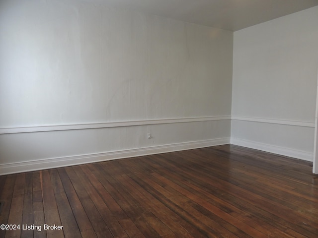 unfurnished room featuring dark wood-type flooring