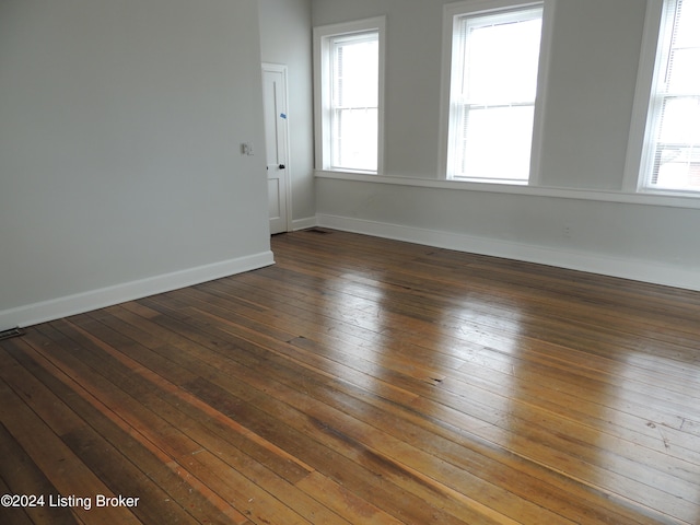 unfurnished room with dark hardwood / wood-style floors