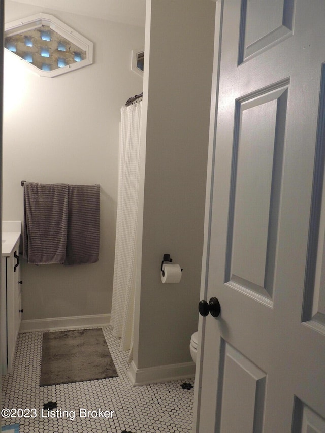 bathroom with vanity, toilet, and tile patterned flooring