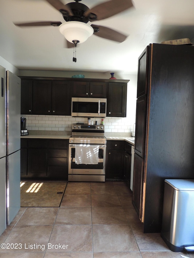 kitchen featuring ceiling fan, dark brown cabinetry, tile patterned flooring, backsplash, and stainless steel appliances