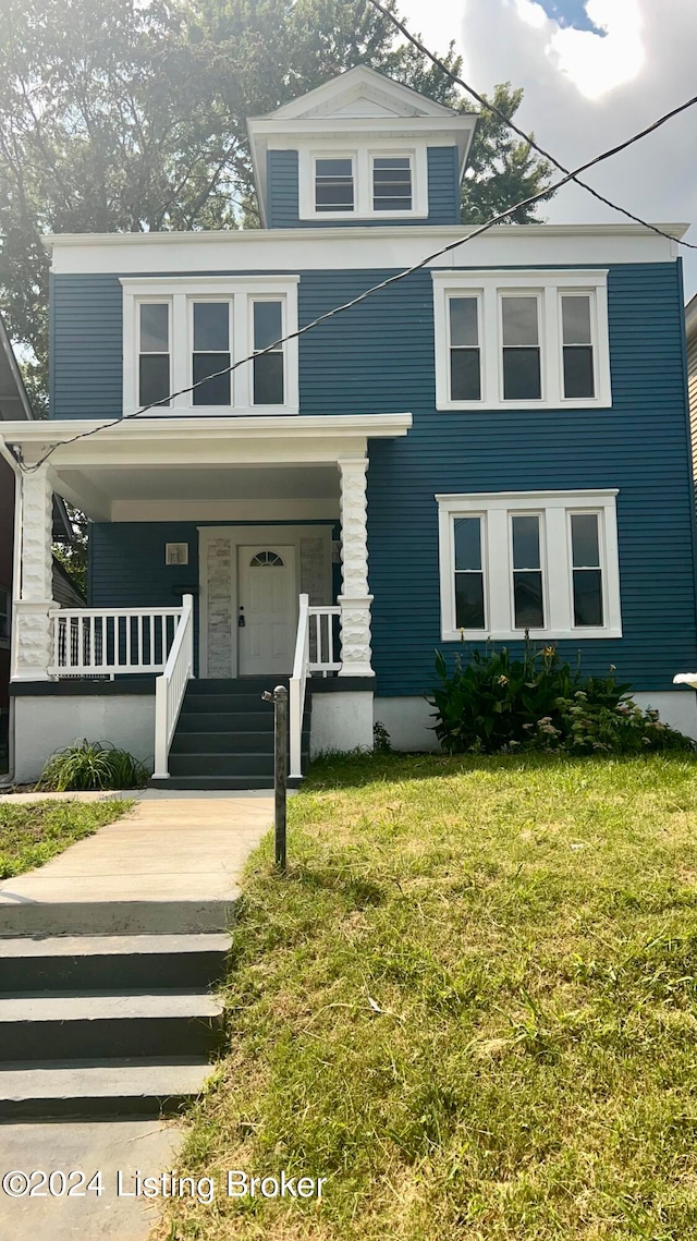 view of front facade with a front yard and a porch