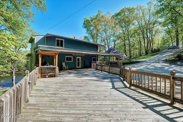 rear view of house featuring a deck