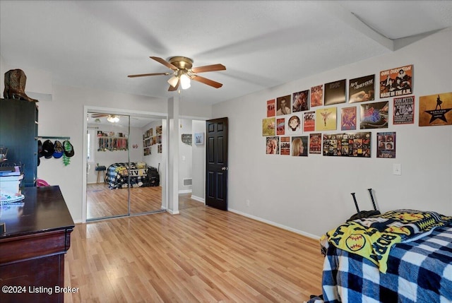 bedroom featuring light hardwood / wood-style flooring, a closet, and ceiling fan