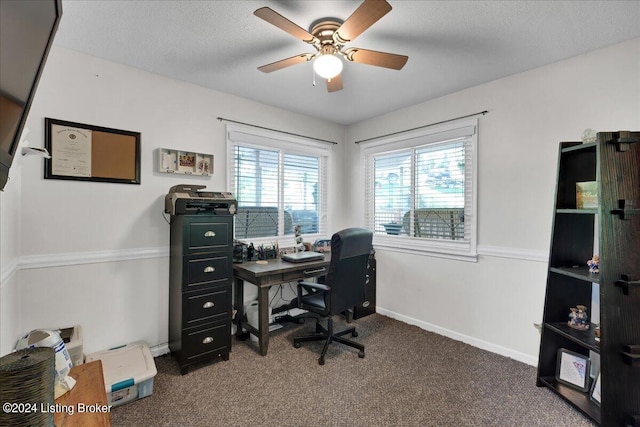 carpeted office with ceiling fan and a textured ceiling