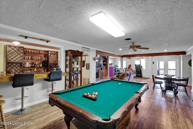 recreation room featuring ceiling fan, pool table, a textured ceiling, and hardwood / wood-style floors