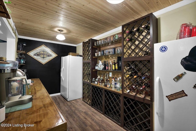 wine room featuring wooden ceiling, dark hardwood / wood-style flooring, indoor bar, and ornamental molding