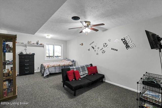 bedroom with a textured ceiling, carpet, and ceiling fan