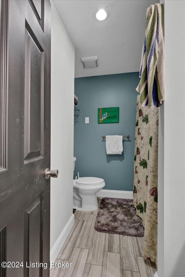 bathroom with toilet and tile patterned floors