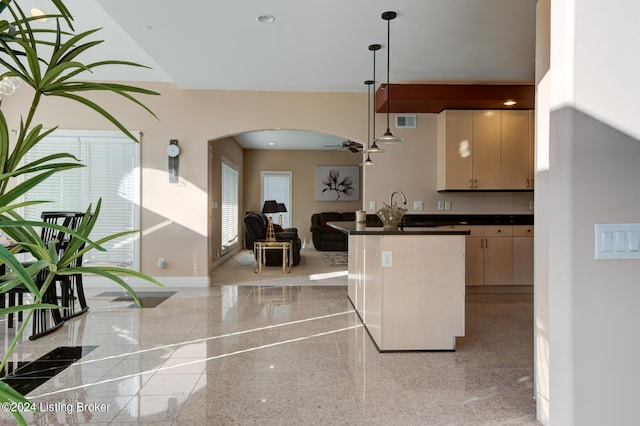 kitchen with ceiling fan, hanging light fixtures, and light brown cabinets