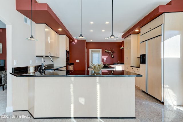 kitchen with sink, kitchen peninsula, pendant lighting, and black appliances