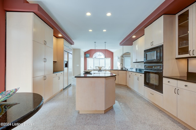 kitchen with kitchen peninsula, sink, black appliances, pendant lighting, and a kitchen island