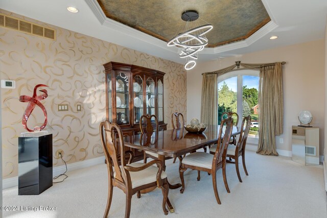 carpeted dining room featuring a raised ceiling and a notable chandelier