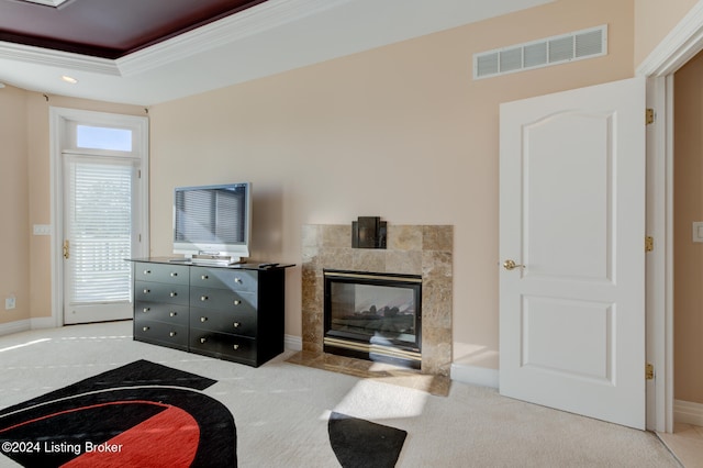 carpeted living room featuring a fireplace and a raised ceiling